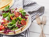 Pannenkoek met gemengde sla, tomaat, olijfjes en frisse yoghurtsaus